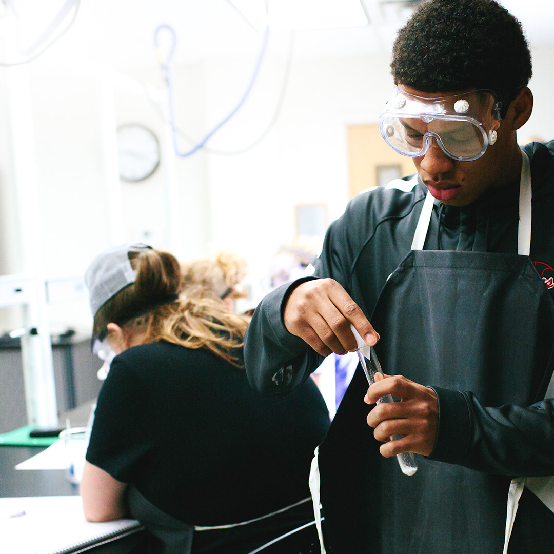 student doing science experiment for christian courses