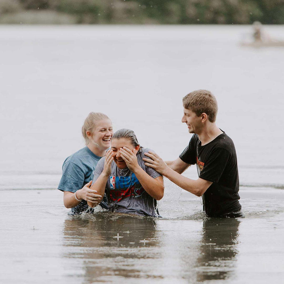 students baptizing other students in biblical studies degree online