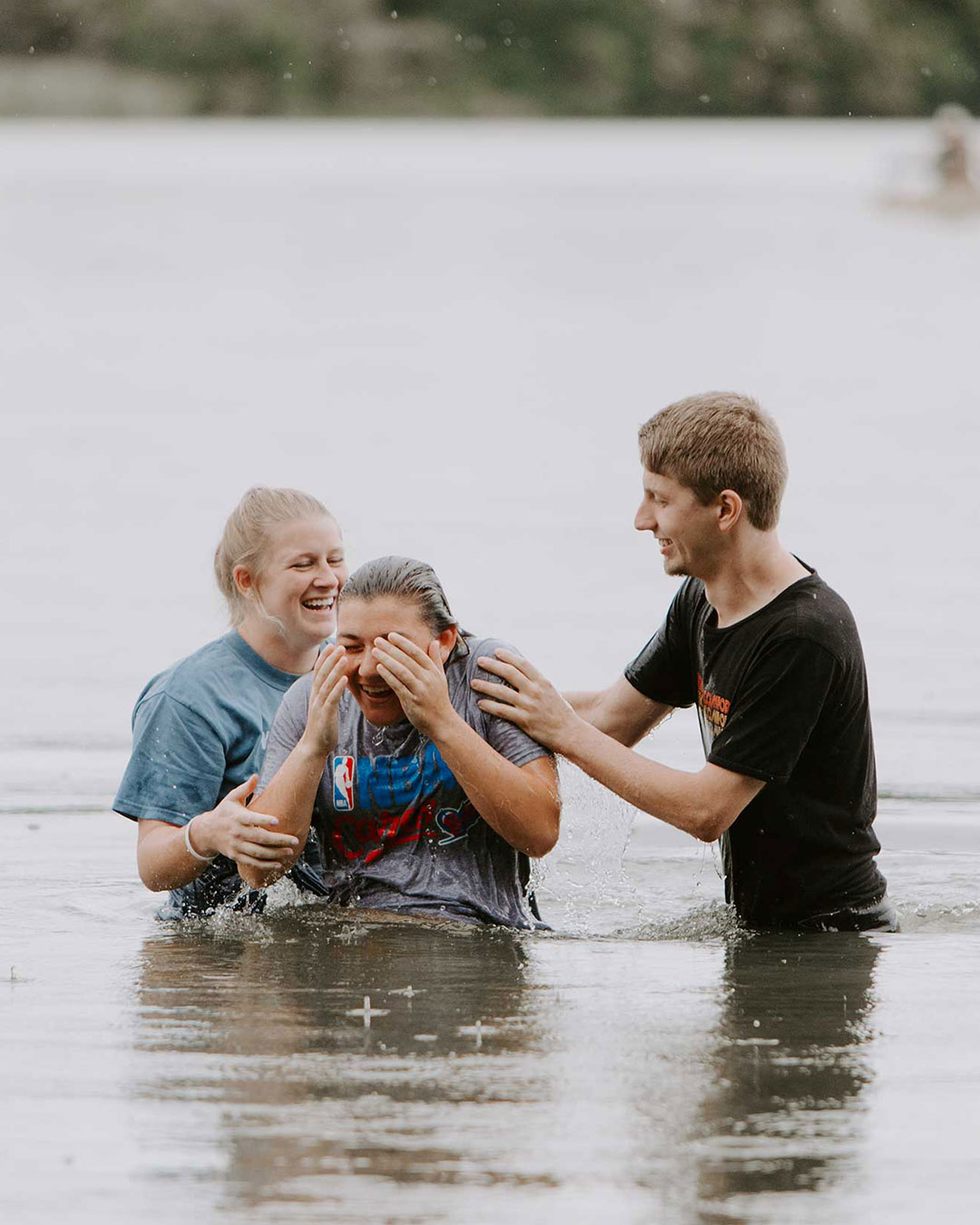 two students baptizing a student a pastoral leadership class