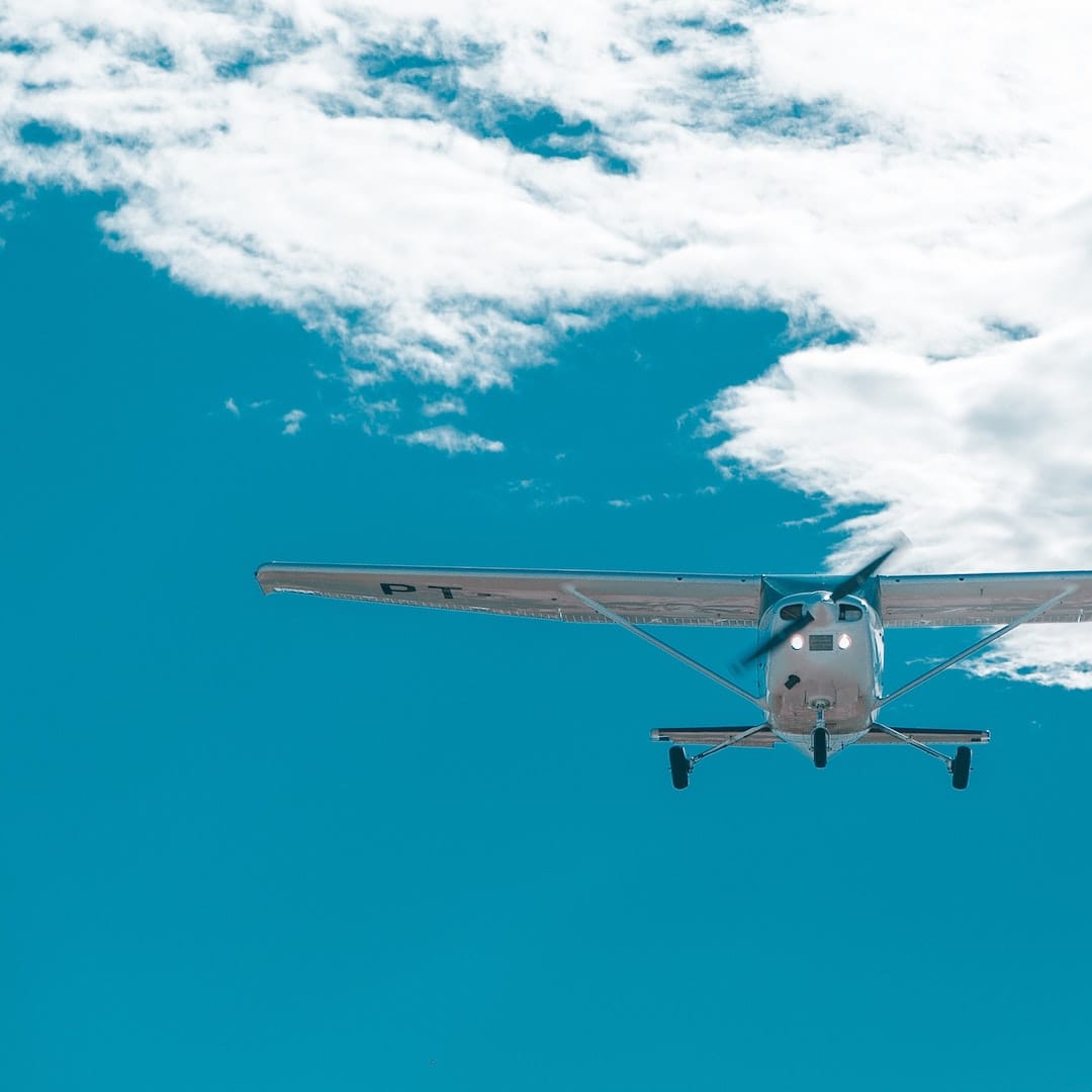 small plane landing blue sky crown college partners